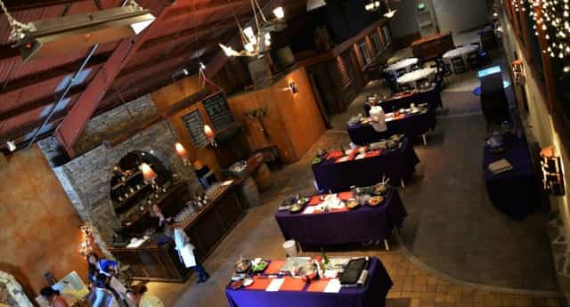 Spacious La Honda Winery tasting room with purple tables, ideal for events and gatherings.