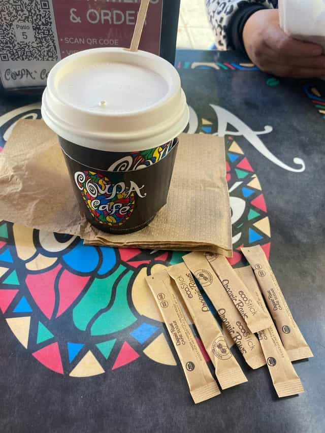 Coffee setup at Coupa Cafe with branded cup, ideal for networking events and meetings.