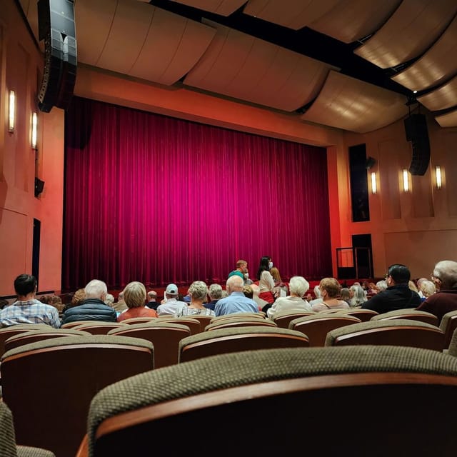 Main Stage at Dragon Theatre with red curtain, perfect for performances and events.