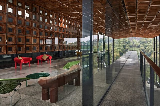 Modern event venue with glass walls and wooden paneling at Gaia Hotel Bandung.