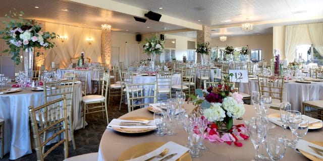 Elegant banquet hall with gold chiavari chairs, ideal for weddings and formal events.