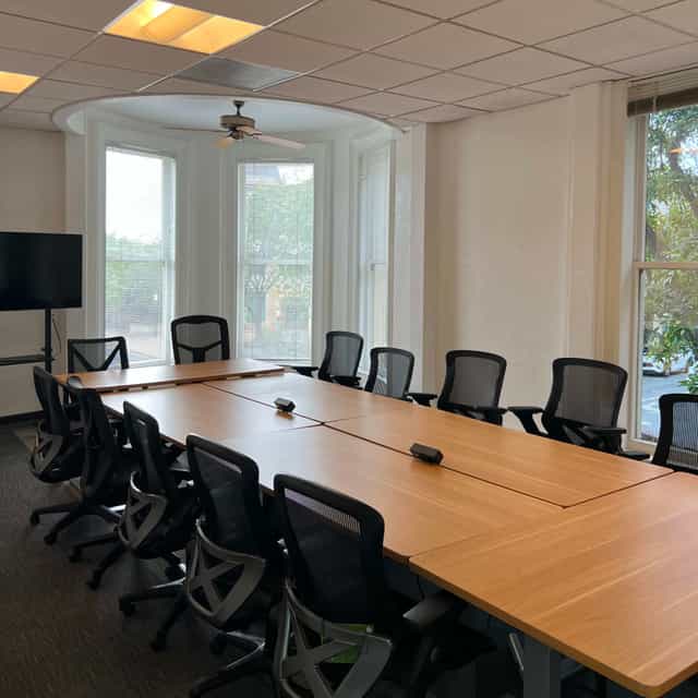 Modern meeting room with large table, ideal for professional gatherings and presentations.