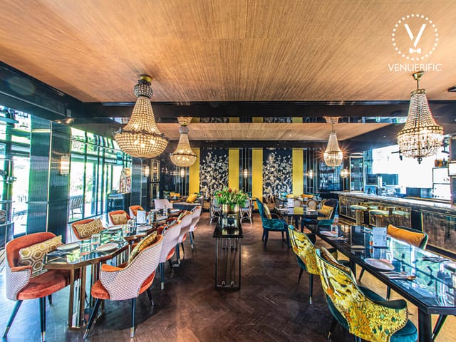 Elegant dining space with colorful seating for upscale corporate events and gatherings.