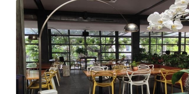 Modern event space at FJ Bistro & Deli with natural light and greenery.