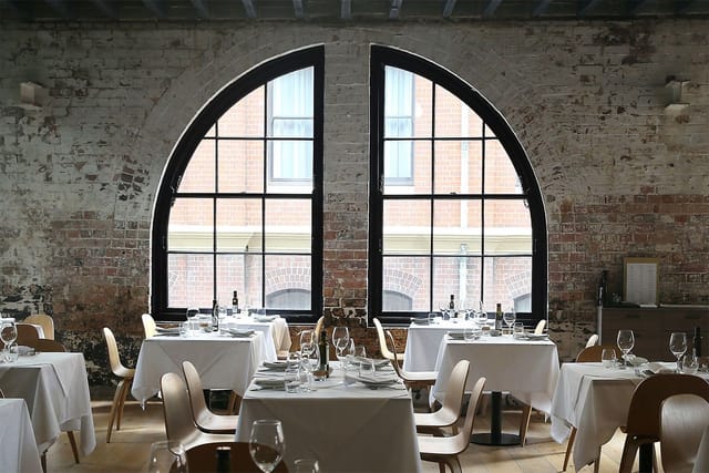 Stylish restaurant with arched windows, ideal for corporate meetings and intimate events.