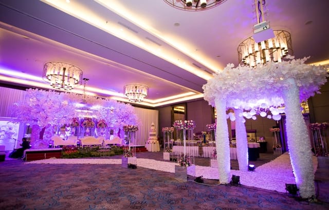 Elegant banquet hall with chandeliers, perfect for weddings and corporate events.