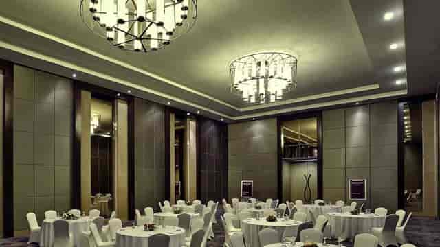 Elegant conference room with round tables, ideal for corporate events and weddings.