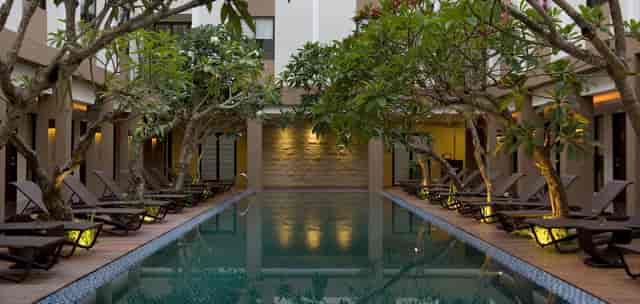 Hotel Santika Kuta Bali courtyard with tranquil pool, perfect for networking events.