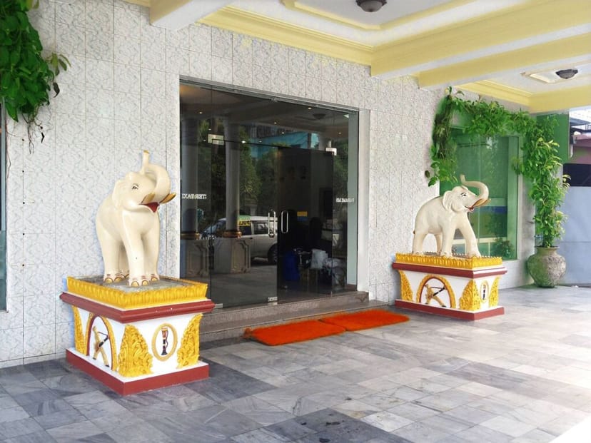 Ornate elephant statues at Royal White Elephant Hotel entrance, perfect for elegant events.