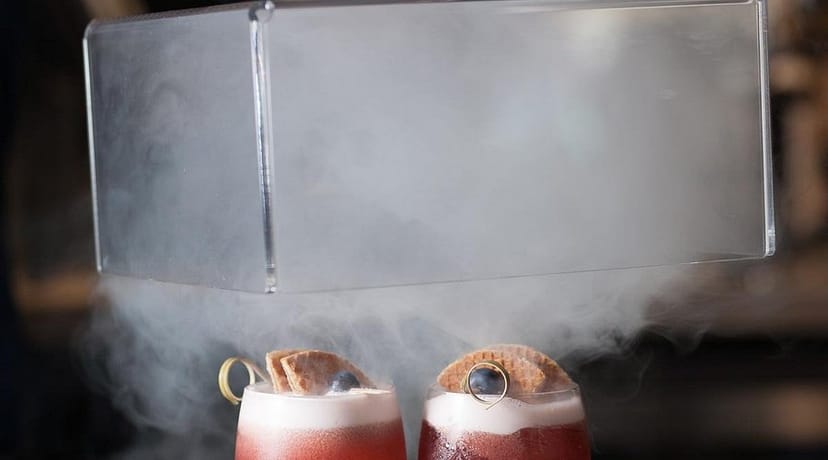 Elegant cocktail presentation with fog at Brunch restaurant, perfect for upscale events.