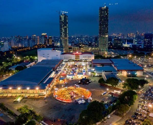 Jakarta International Expo at night, trade fair atmosphere with vibrant cityscape.