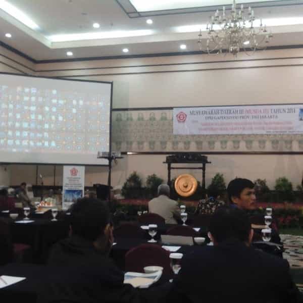 Ballroom at Hotel Grand Cempaka, tables set for a conference, professional networking event.