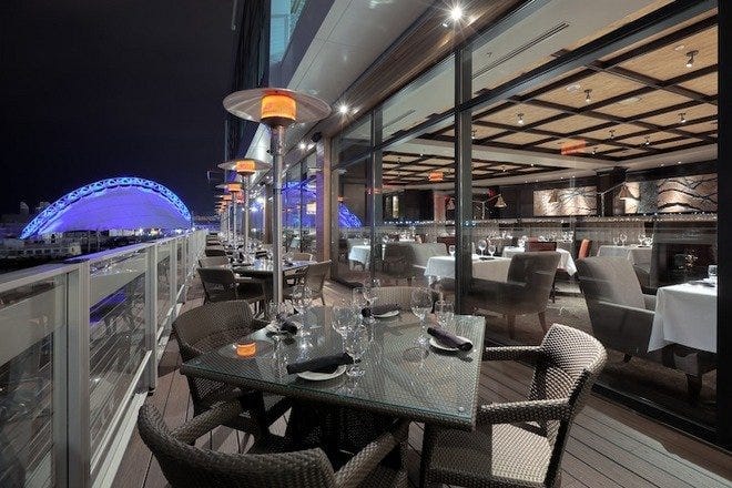 Outdoor bar at Del Frisco’s Steak House, featuring elegant seating for upscale events.