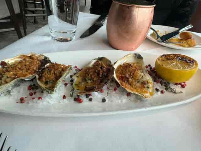 Baked oysters on ice at Del Frisco’s for upscale events and networking dinners.