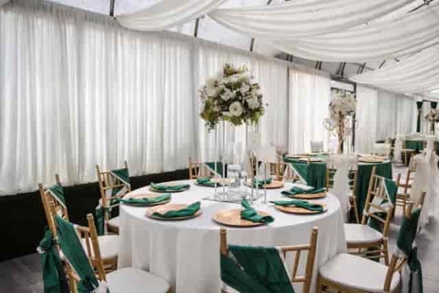Elegant graduation event setup with round tables and floral centerpieces at Le Jardin.