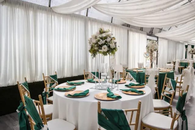 Elegant graduation event setup with round tables and floral centerpieces at Le Jardin.