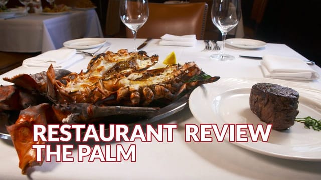 Elegant dining table with seafood and steak at upscale corporate event venue.