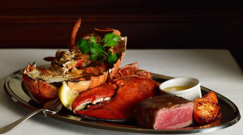 Surf and turf dish with lobster and steak, perfect for upscale events at The Palm Restaurant.