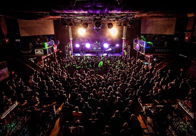Packed Warehouse Venue in Houston, vibrant lighting for successful events, crowd management.