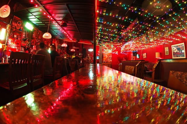 Vibrant Shoeshine Charley's lounge with colorful lights for lively gatherings and events.