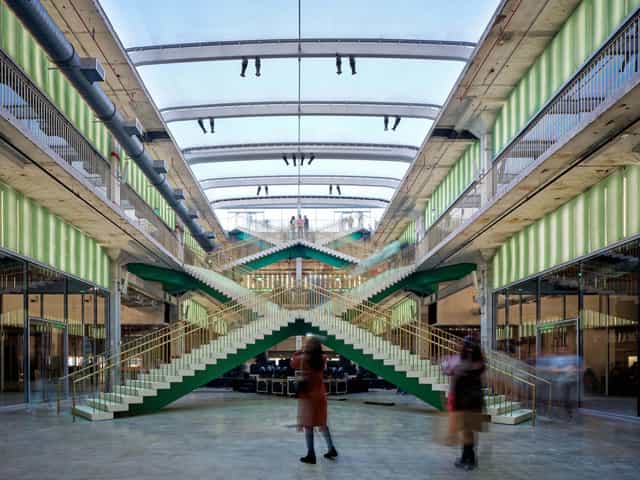 Modern event space in X Atrium with double staircase for corporate meetings and gatherings.