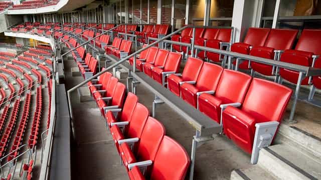 Luxury Suites at NRG Park with red seating, perfect for events and networking.
