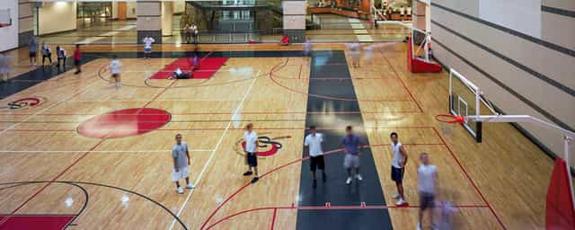 Campus Recreation and Wellness Center gym with polished wooden floor for sports events.