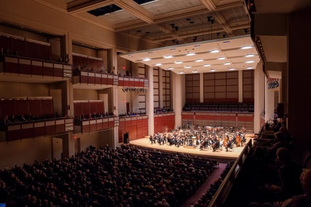 Raleigh Memorial Auditorium concert hall with orchestra, ideal for live performances and events.