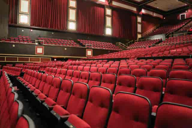 Raleigh Memorial Auditorium with red seating, ideal for conferences and performances.