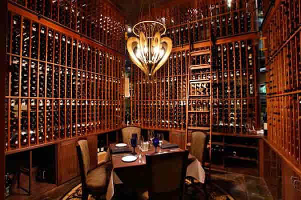 Formal dining room wine cellar at Champions Golf Club for exclusive corporate dinners.