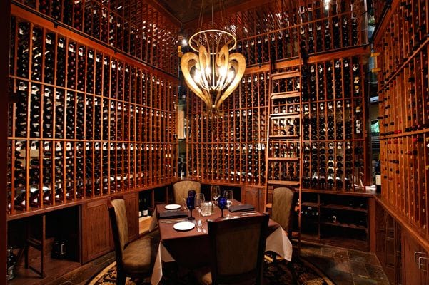 Formal dining room wine cellar at Champions Golf Club for exclusive corporate dinners.