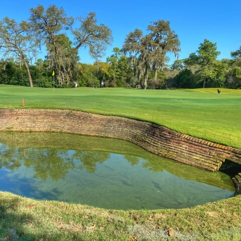 Cypress Bar at Champions Golf Club with serene water feature, ideal for corporate events.