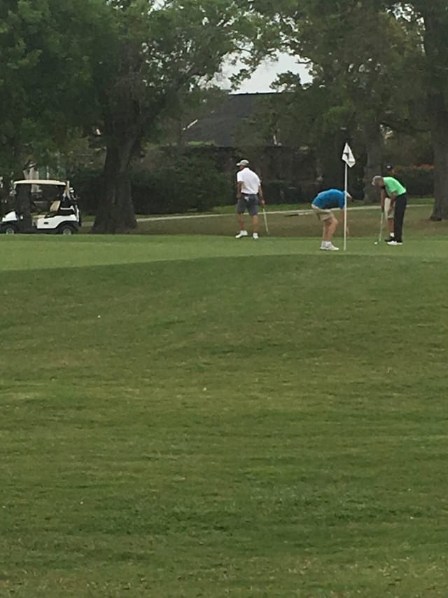 BlackHorse Golf Club tranquil course with golfers, perfect for corporate outings and networking.