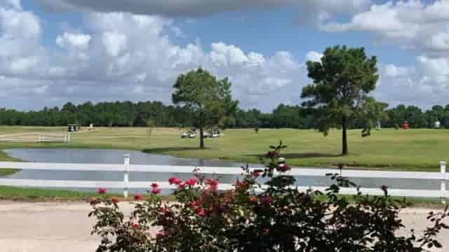 Outdoor wedding venue at Golf Club of Houston with lush greenery and tranquil water feature.