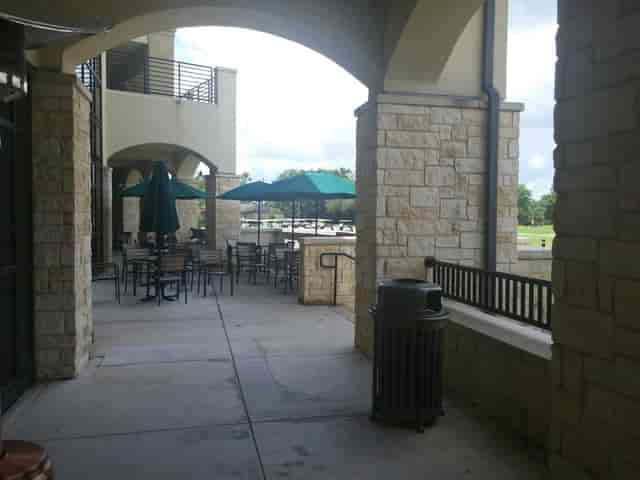 Bluebonnet Grille patio with green umbrellas, perfect for outdoor networking events.