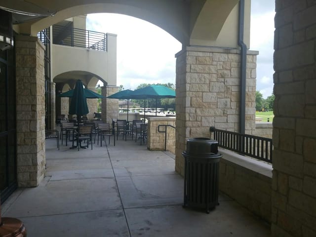 Bluebonnet Grille patio with green umbrellas, perfect for outdoor networking events.