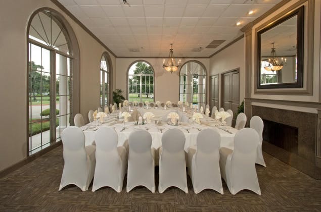 Elegant event space with round tables for corporate gatherings at Sugar Creek Country Club.