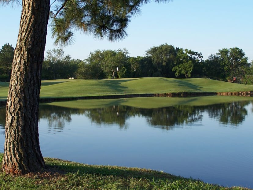 Serene Jersey Meadow Golf Course with lush greenery and tranquil pond for outdoor events.