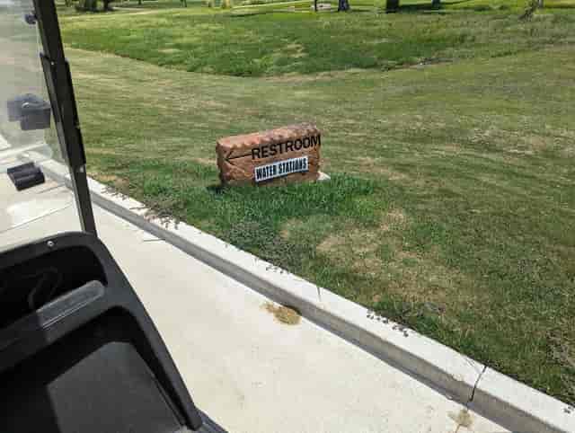 Restroom sign at Jersey Meadow Golf Course for outdoor event convenience.