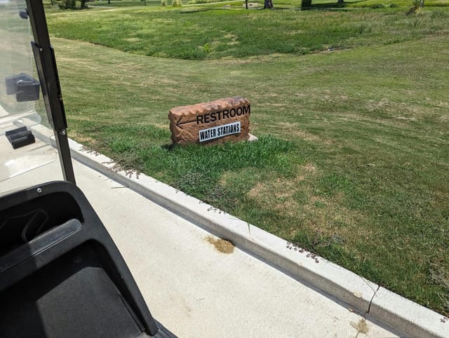 Restroom sign at Jersey Meadow Golf Course for outdoor event convenience.