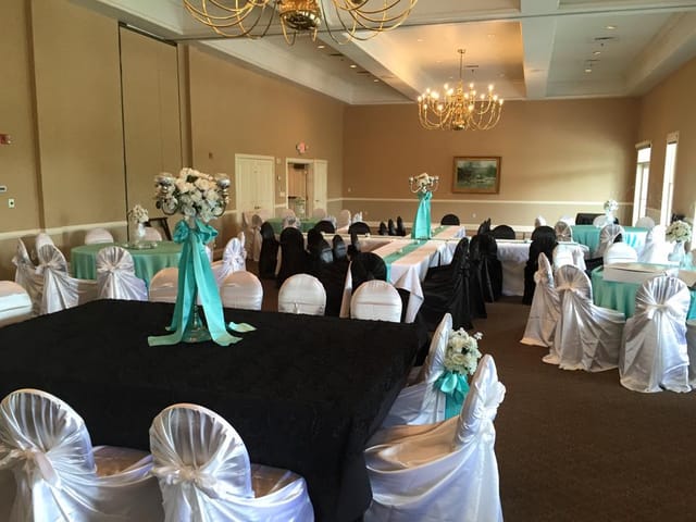 Elegant dining room setup with black and white decor for formal events at The Club at Pecan Grove.
