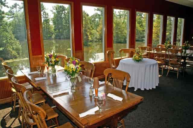 Charming restaurant event space with large windows, ideal for corporate retreats and gatherings.