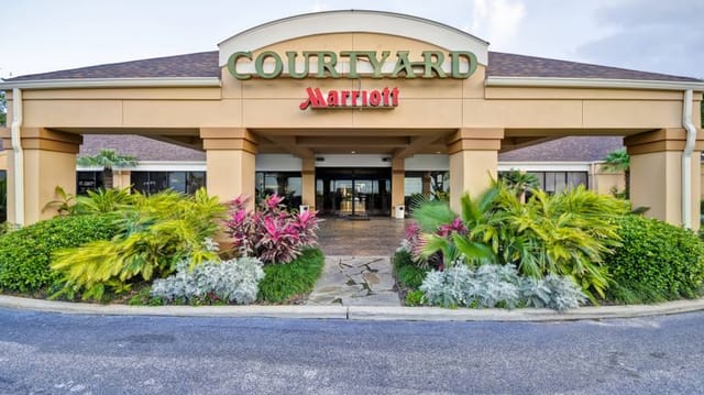 Courtyard by Marriott Houston with tropical landscaping, perfect for events and meetings.