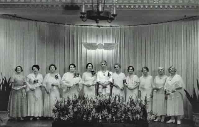 Elegant women's gathering at Pyramid, Unity of Houston; recognition ceremony, floral decor.
