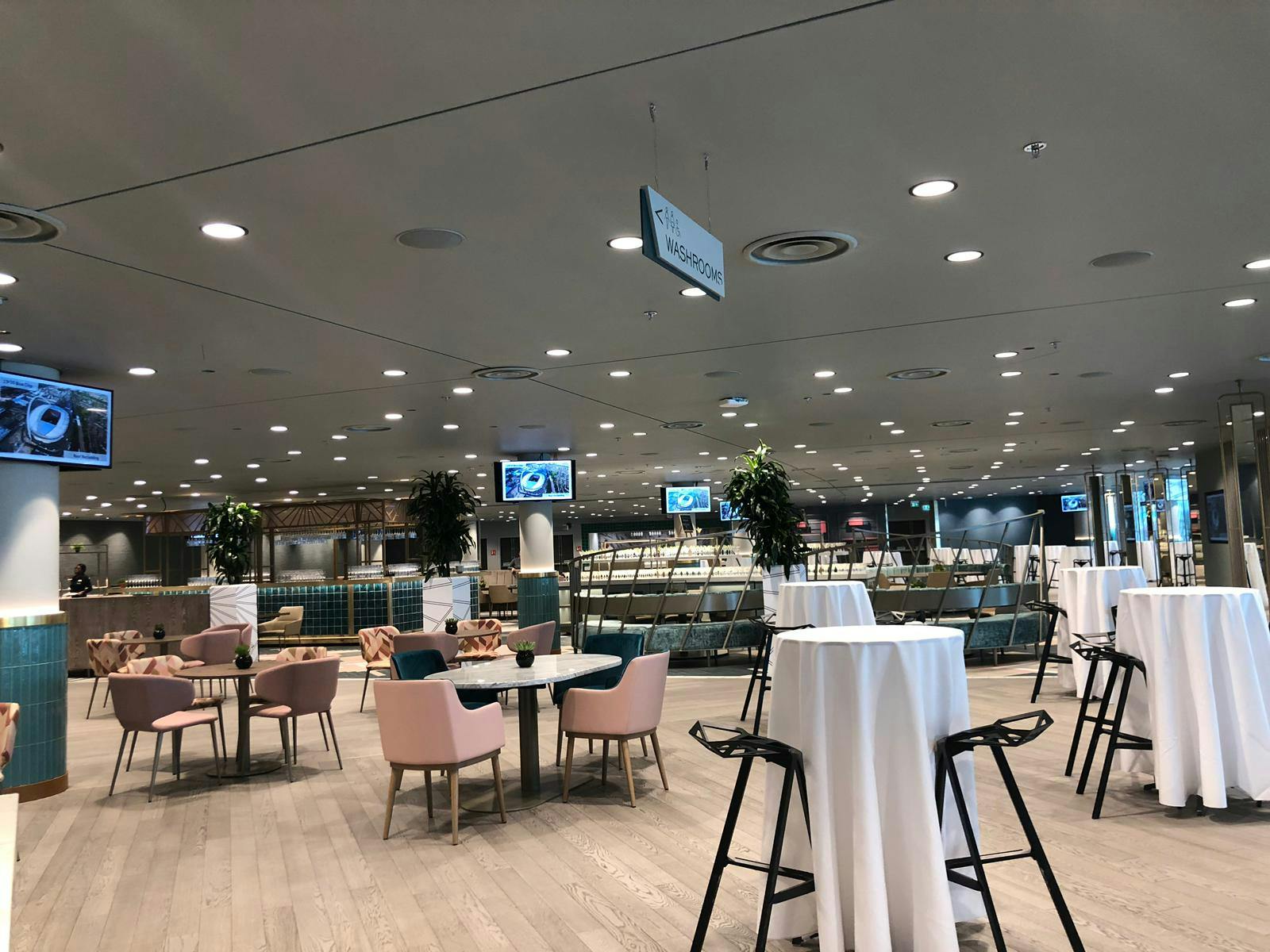 Wembley Stadium Atrium: modern event space with high-top tables for networking events.