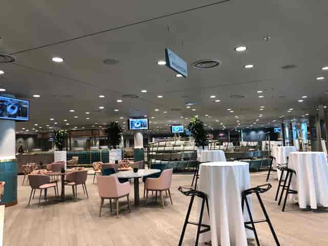 Wembley Stadium Atrium: modern event space with high-top tables for networking events.