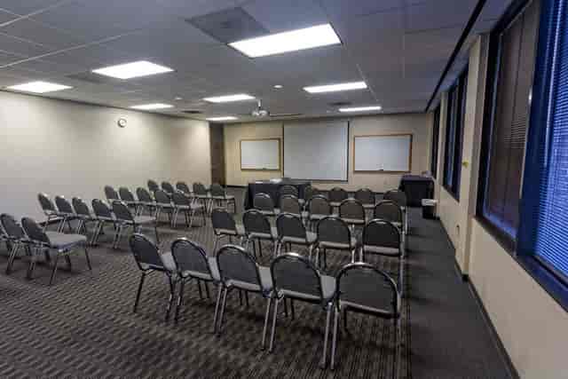 Norris Conference Centers meeting room setup for workshops with natural light and projector.