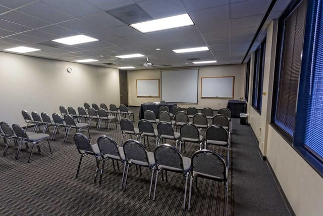 Norris Conference Centers meeting room setup for workshops with natural light and projector.