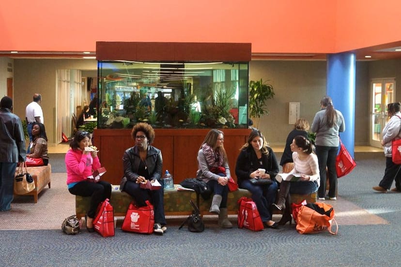 Banquet hall at KBC Houston: networking event with casual seating by aquarium.