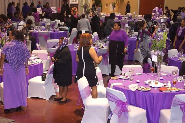 Elegant banquet hall setup with purple decor at The KBC Houston event.